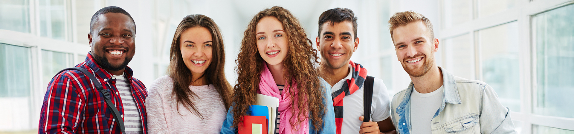 Students standing next to each other smiling Students standing next to each other smiling