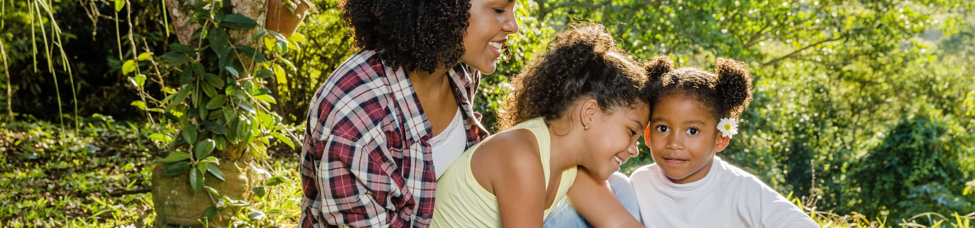 Mother sitting together with her two daughters